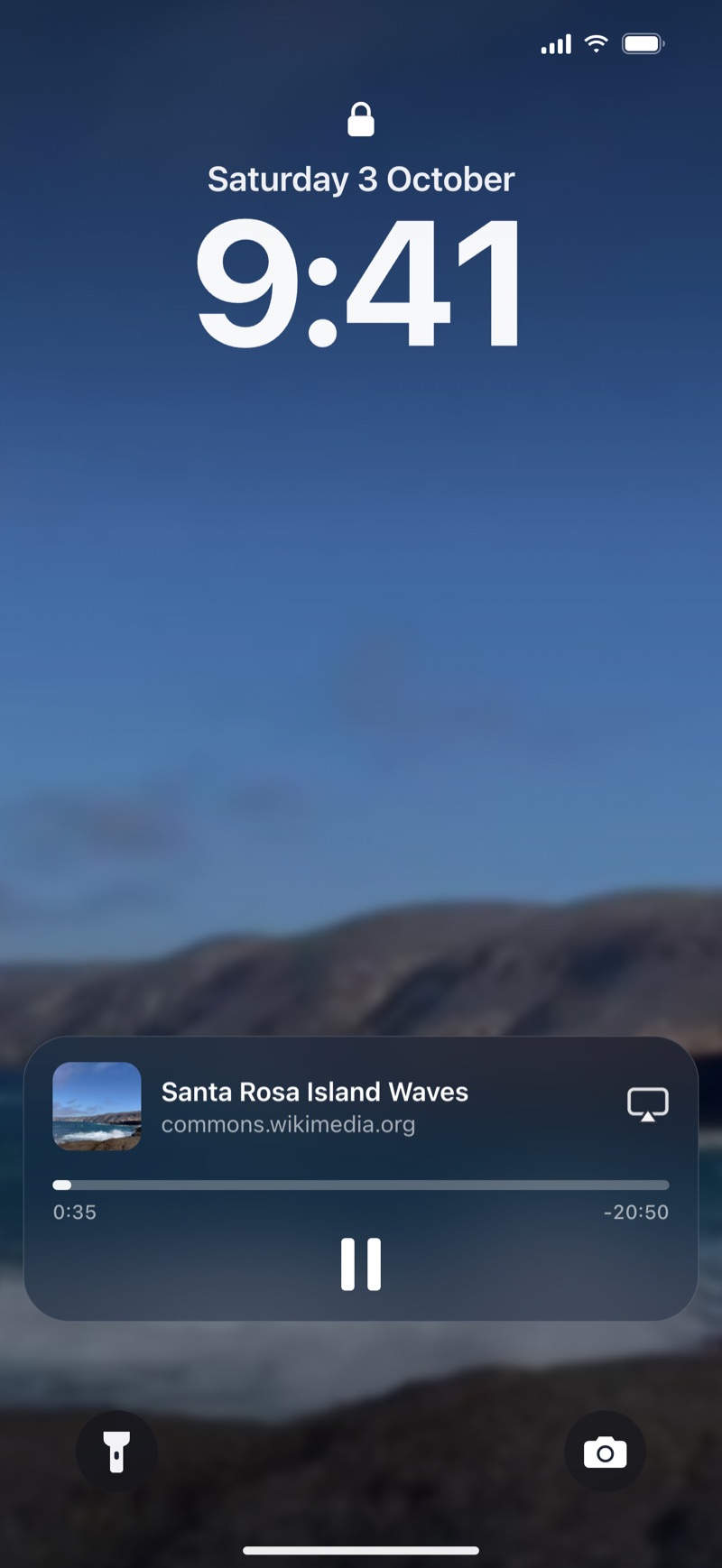 The Lock Screen, with the ocean waves video still playing in its Now Playing controls